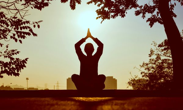 pexels-photo-1051838-1051838 Silhouette of a person practicing yoga outdoors during sunrise, creating a calming atmosphere.
